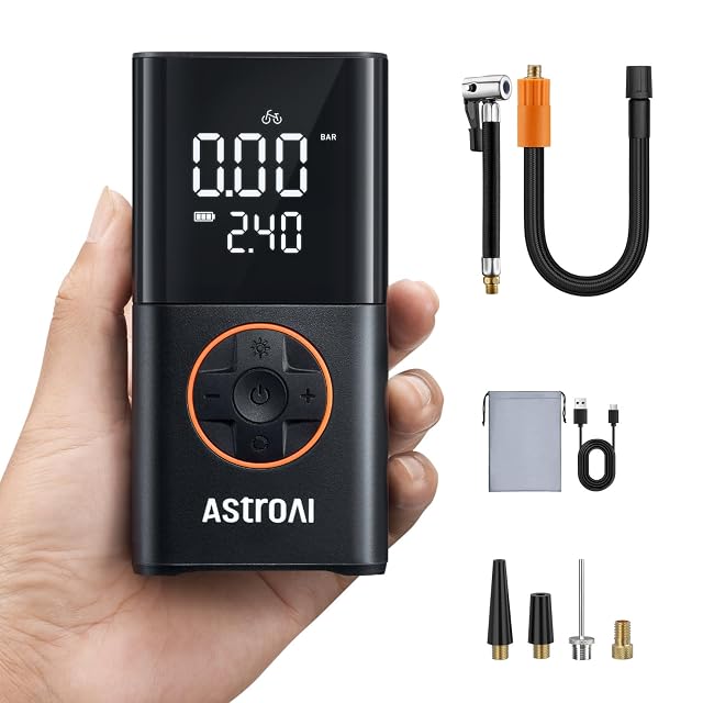 AstroAI cordless tire inflator held in one hand, display showing pressure